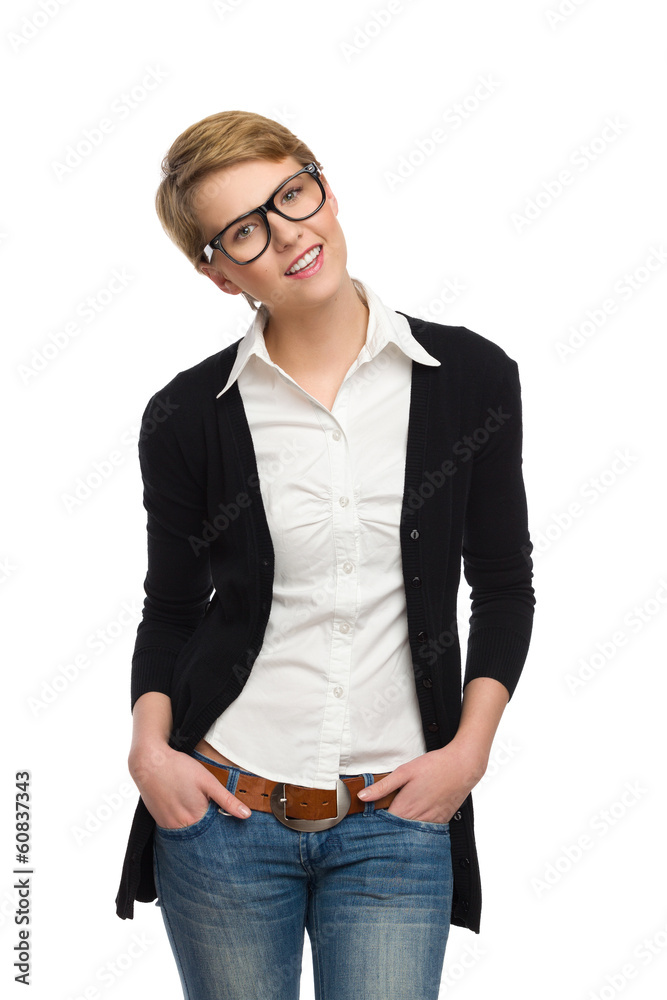 Cheerful young woman with hands in pockets.