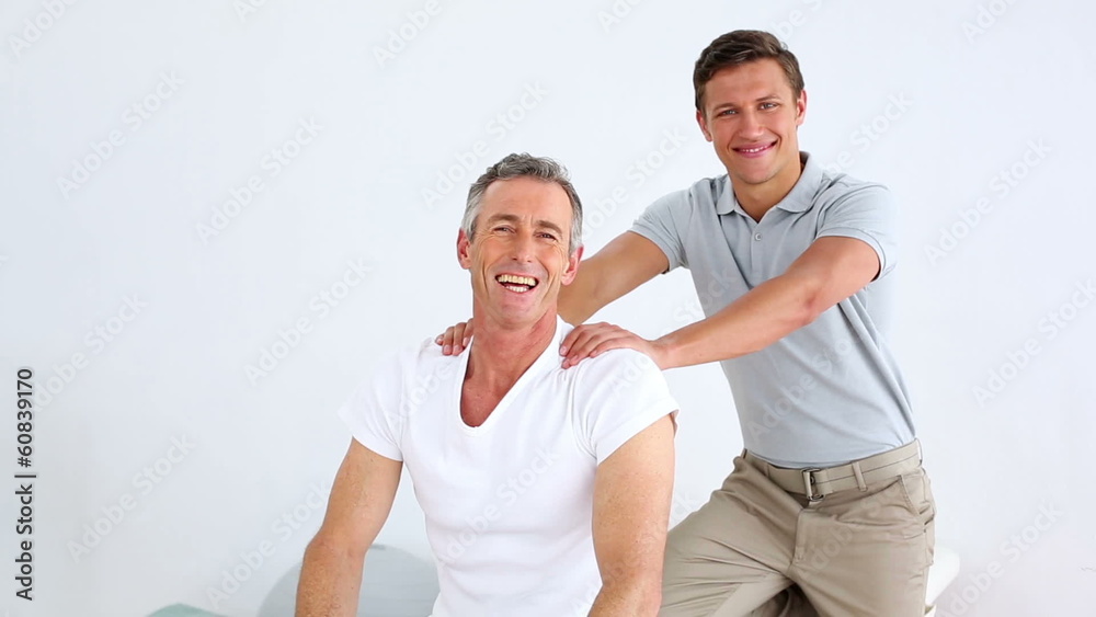 Physiotherapist checking senior patient resistance Physiotherapist checking senior patient resistance