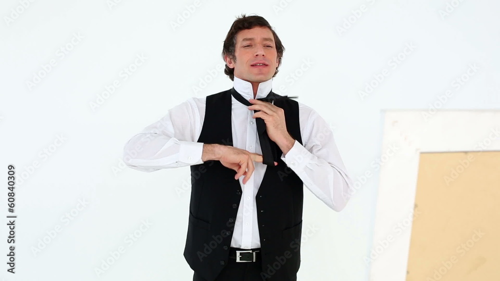 Groom getting ready for his wedding smiling at camera