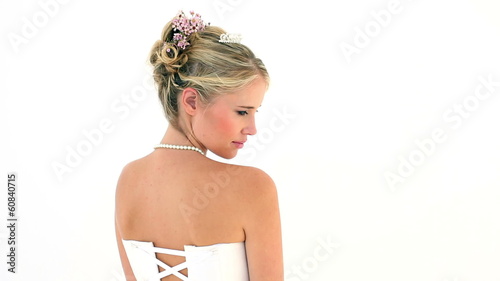 Blonde bride turning to smile at camera