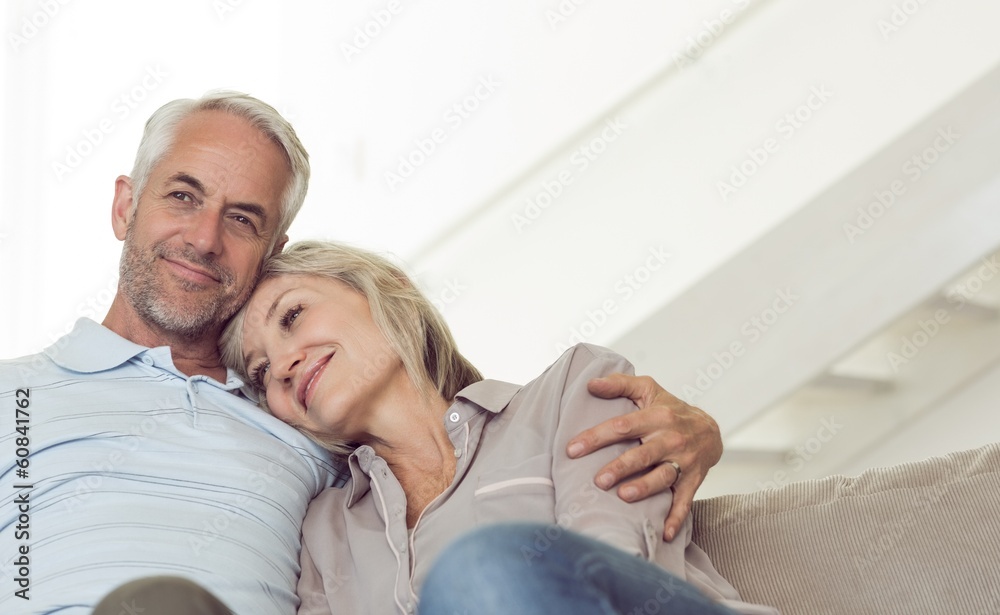 Relaxed mature couple sitting on sofa
