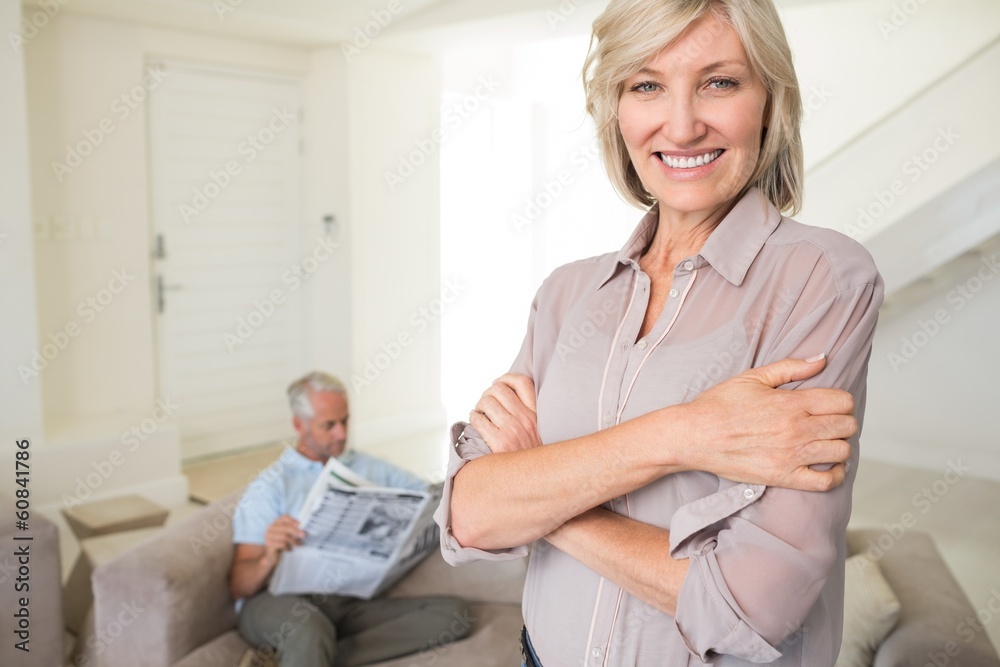 Smiling woman with man reading newspaper at home Smiling woman with man reading newspaper at home
