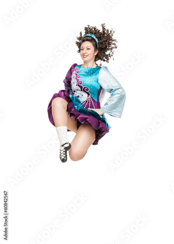 Young woman in irish dance dress jumping