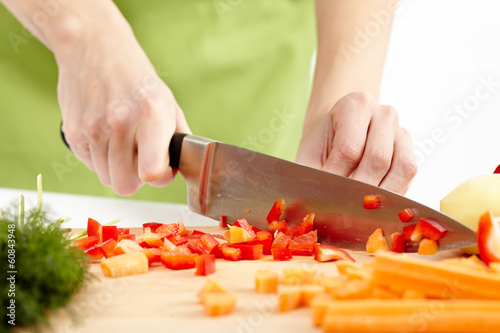 Young lady chopping vegetables