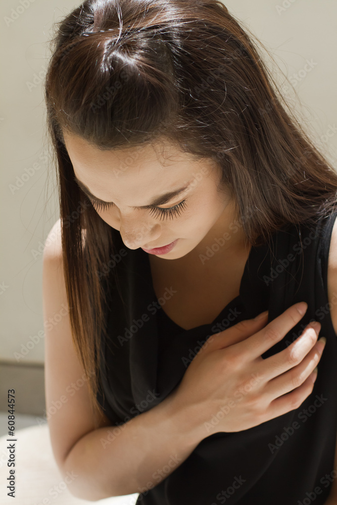 Fototapeta premium heart problem or chest pain, female model