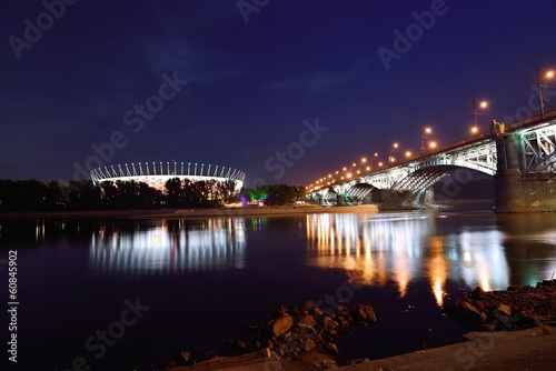 Poniatowski Bridge and National Stadium in Warsaw by night.
