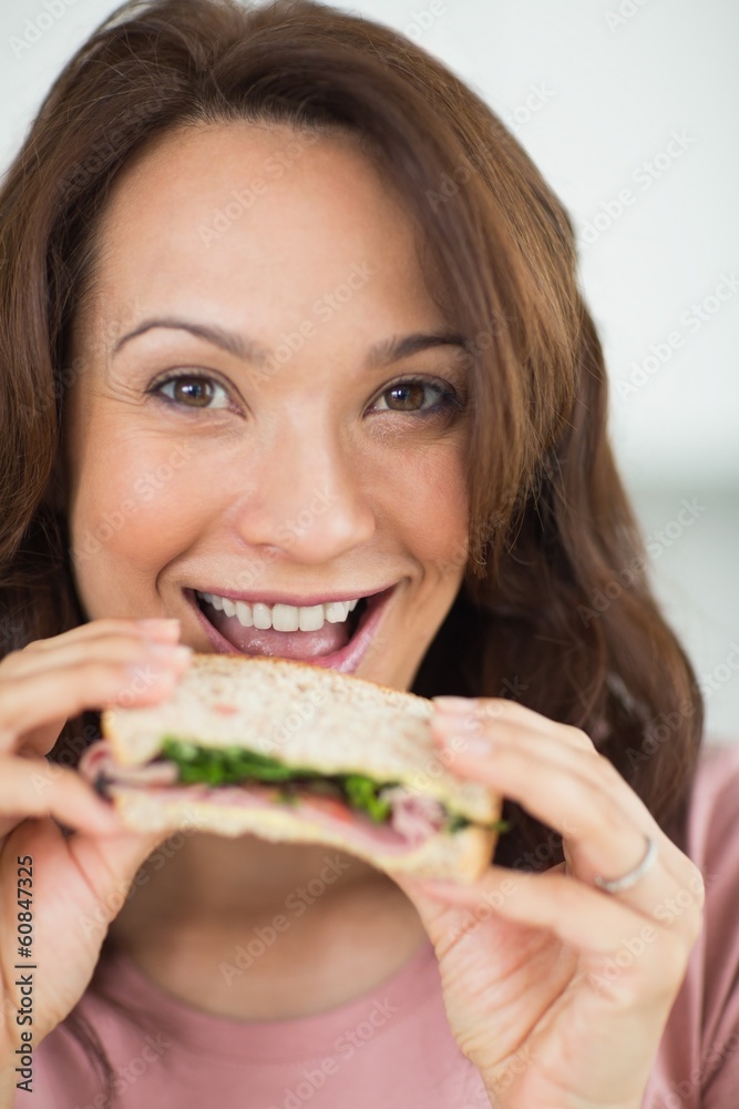 Closeup portrait of a woman eating sandwich