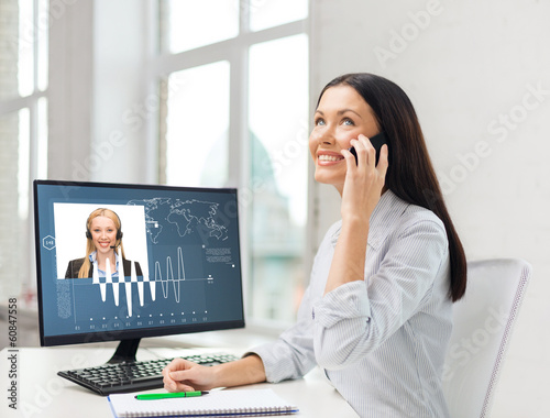 smiling businesswoman or student with smartphone