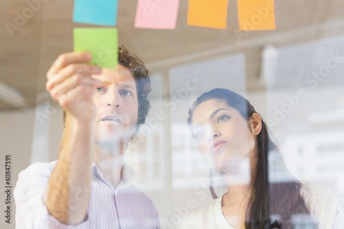 Business people sticking adhesive notes