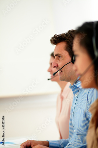 Man and women operator working with headphones