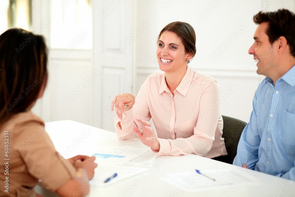 Adult professional colleagues working and smiling Adult professional colleagues working and smiling
