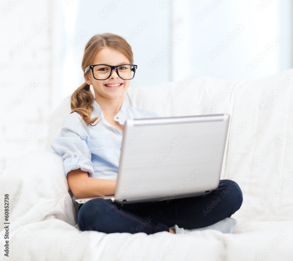 smiling girl in specs with laptop computer at home smiling girl in specs with laptop computer at home