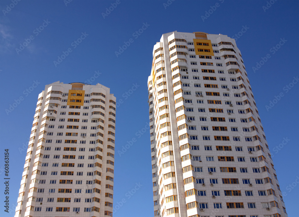 Front view of two new constructed buildings over blue sky Front view of two new constructed buildings over blue sky