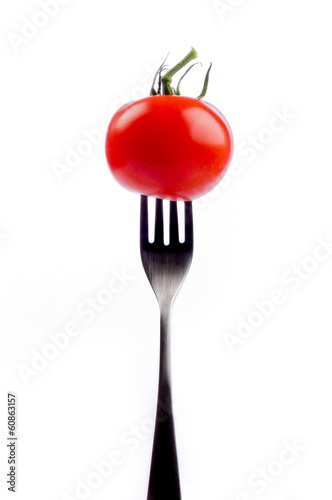 red tomato on fork