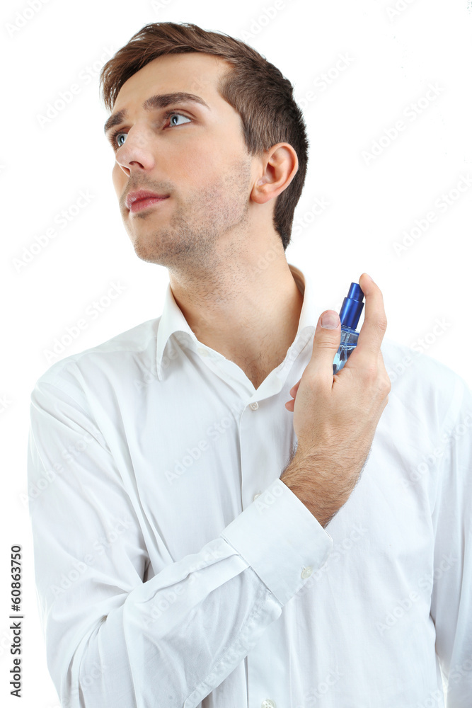 Handsome young man using perfume isolated on white Handsome young man using perfume isolated on white