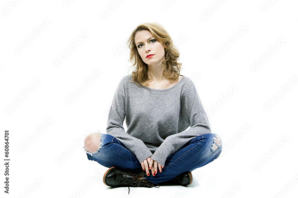 Beautiful blond woman sitting on floor