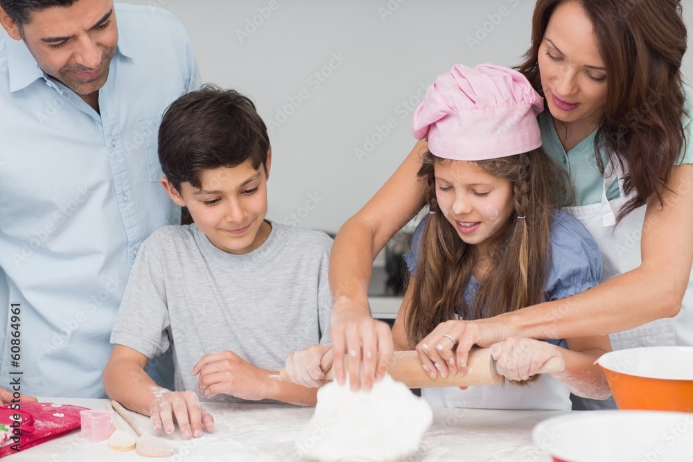 Family of four preparing cookies in the kitchen Family of four preparing cookies in the kitchen