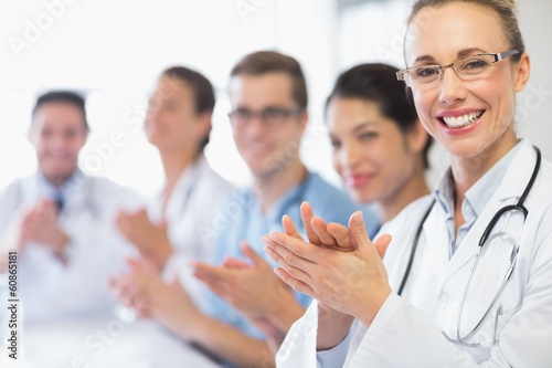 Happy doctor and team clapping