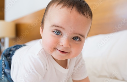 Smiling baby boy in bed