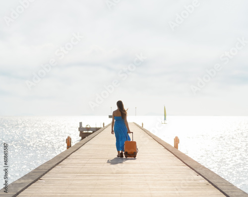 Young woman walking on wooden pier