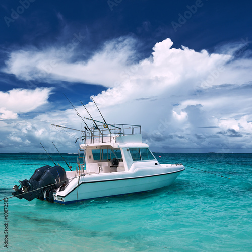 Beautiful island beach with motor boat photo