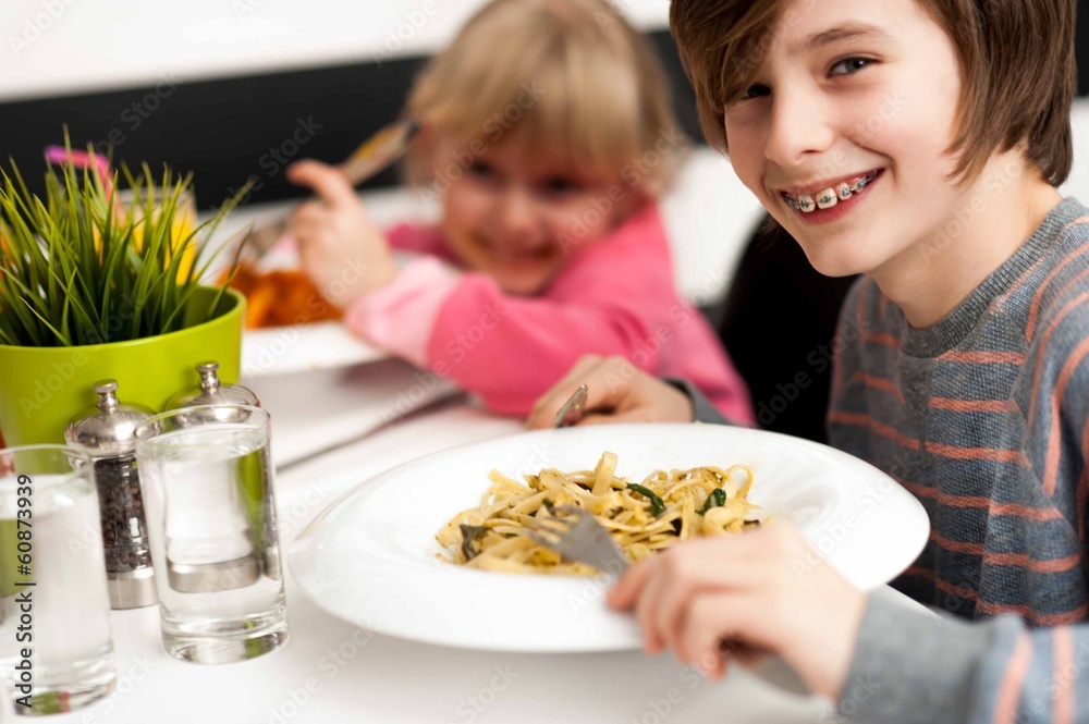 Children enjoying their meals Children enjoying their meals
