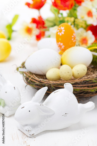 Easter rabbits and basket with eggs, close-up