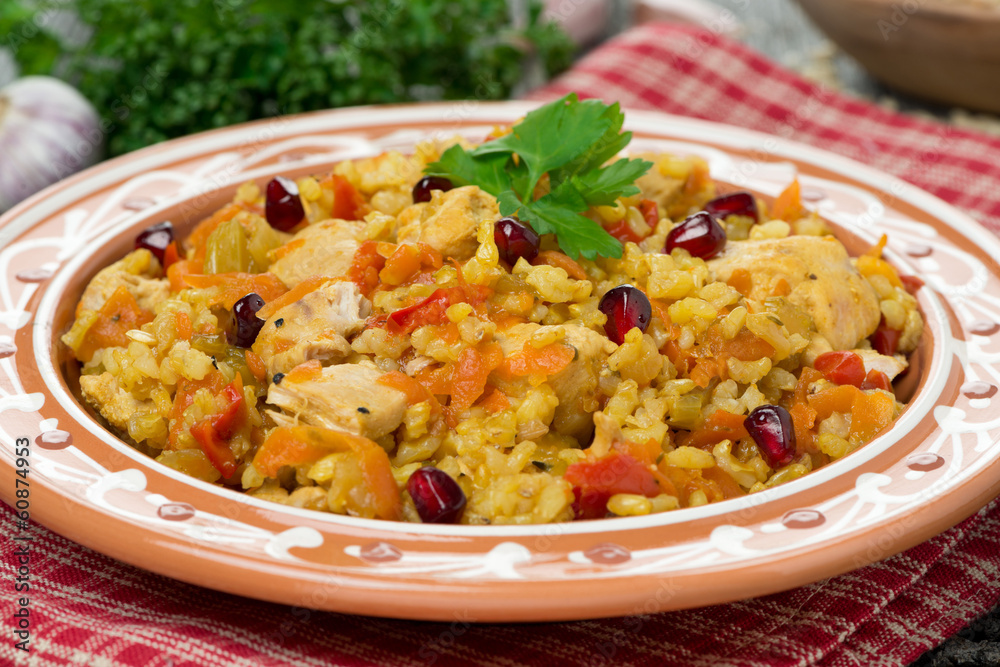 pilaf with vegetables, chicken and pomegranate, close-up pilaf with vegetables, chicken and pomegranate, close-up