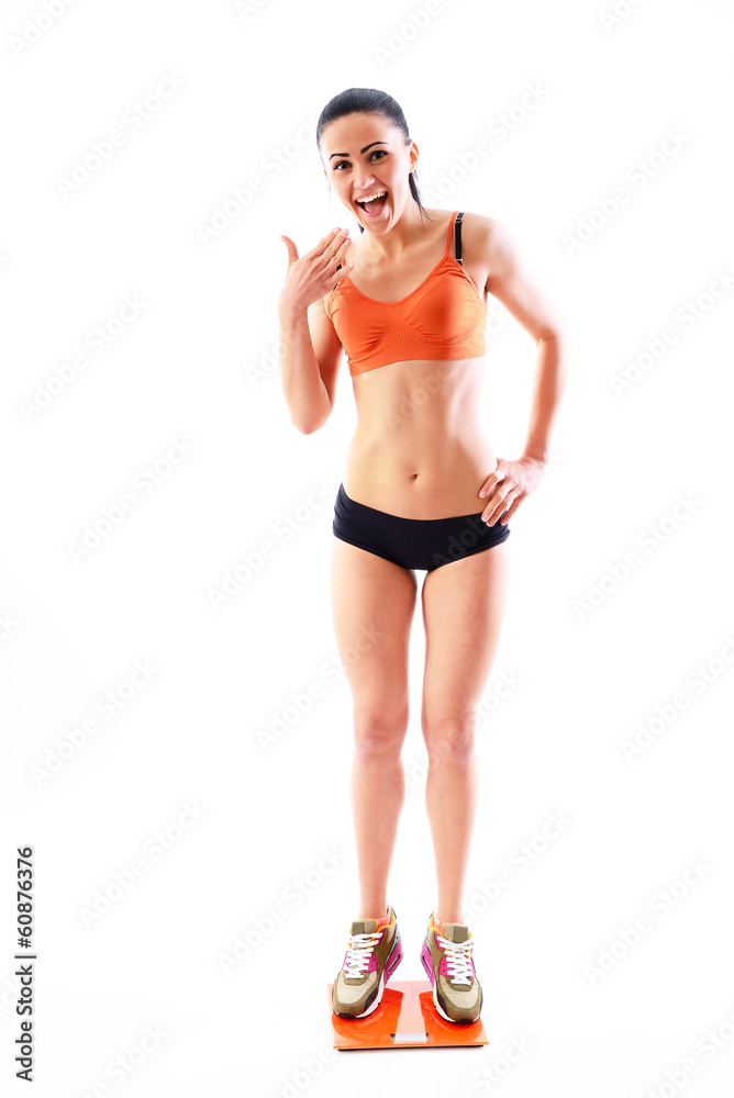 Young woman with scale happy of weightloss and a healthy slim bo Young woman with scale happy of weightloss and a healthy slim bo