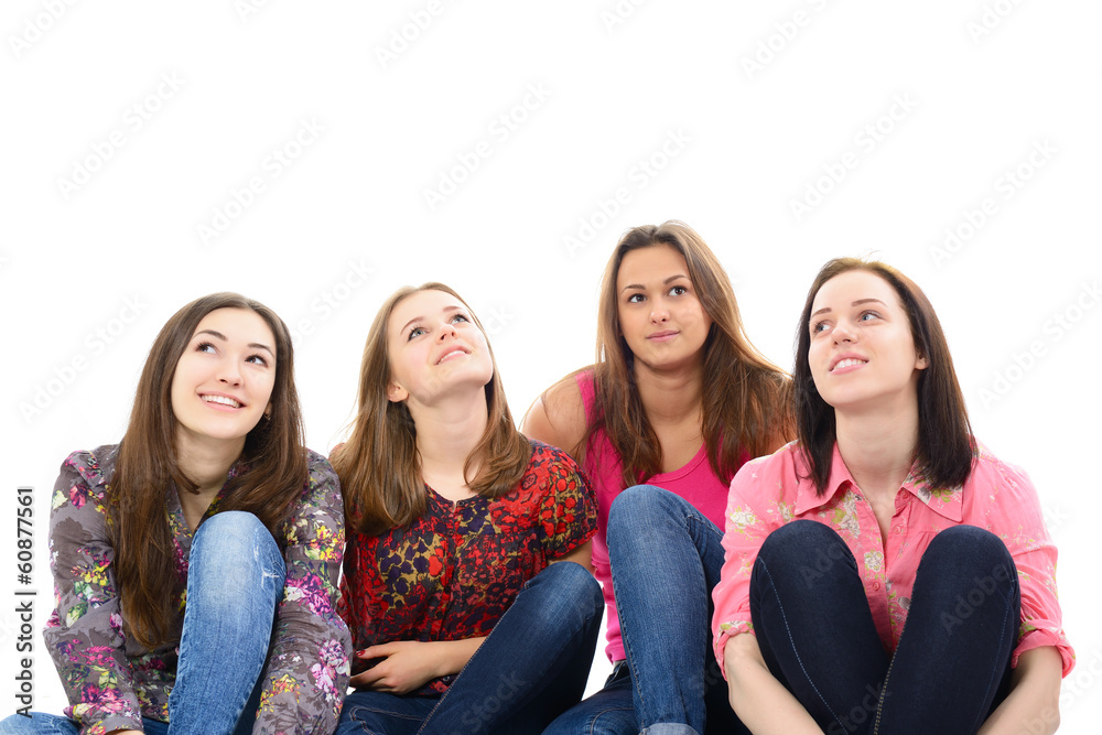 happy young women sitting together smiling and looking up and dr happy young women sitting together smiling and looking up and dr