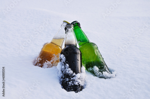 Three bottles of beer in the snow