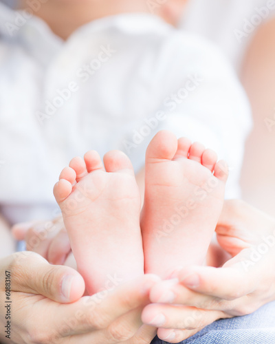 Baby feet in mothers hands © Sunny studio