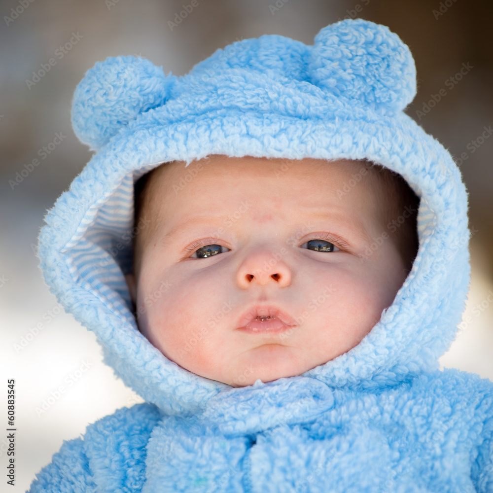 Cute infant baby boy wearing fluffy snow suit during winter Cute infant baby boy wearing fluffy snow suit during winter