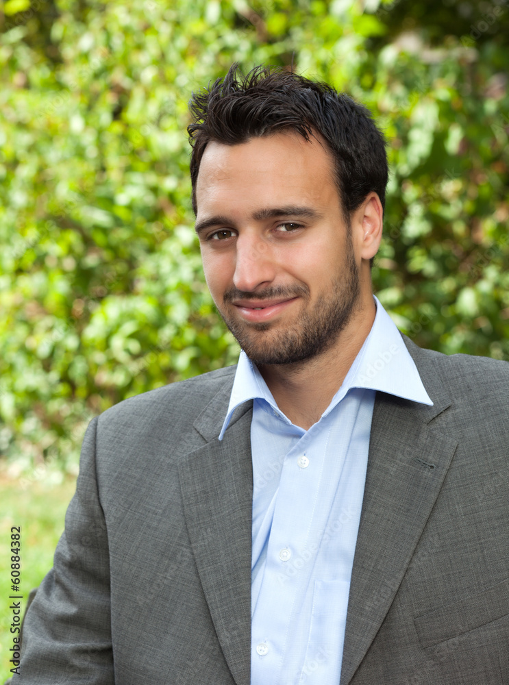 Attractive latin businessman in a park Attractive latin businessman in a park