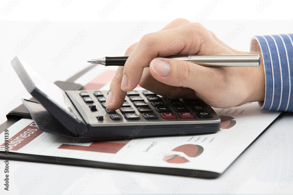 Fototapeta premium Male hand with pen analyzing financial data