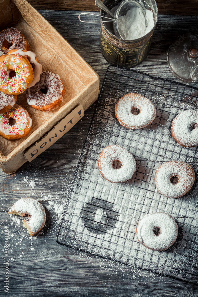 Tasting sweet donuts with icing sugar Tasting sweet donuts with icing sugar