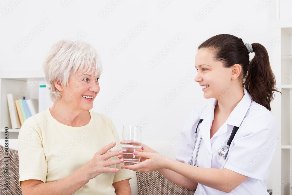 Young Doctor With Patient Holding Glass Young Doctor With Patient Holding Glass