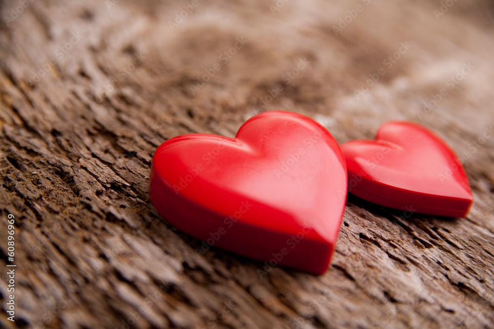 Fototapeta premium Love of red hearts on wooden background