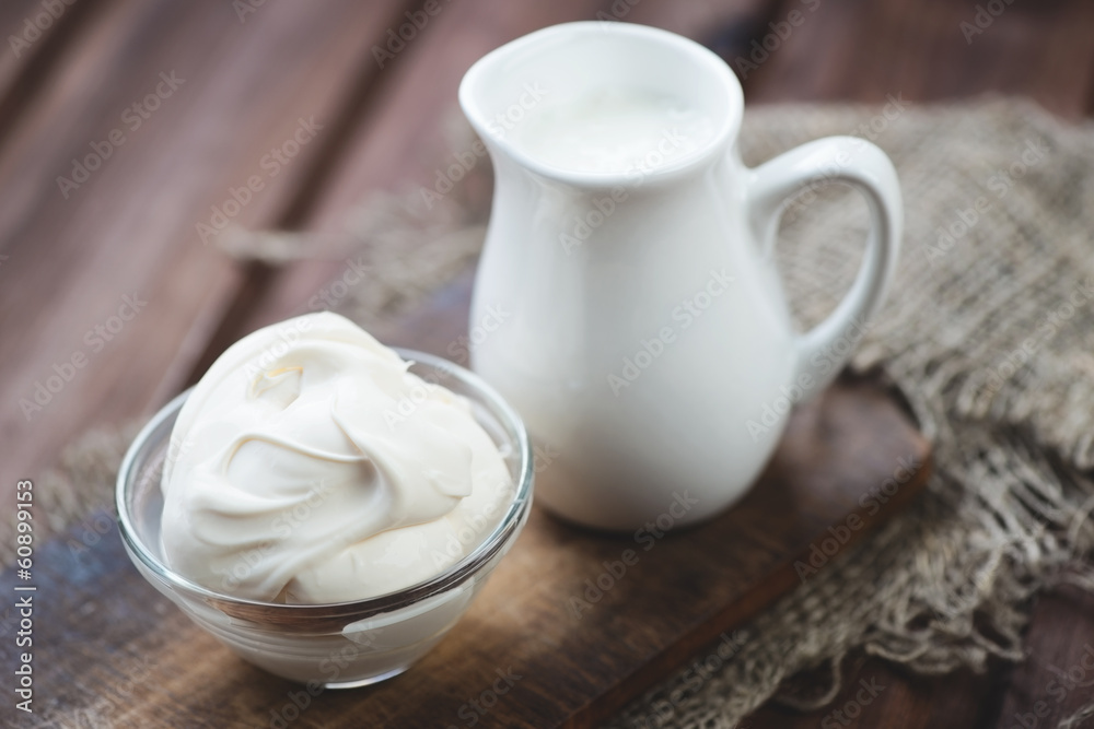 Sour cream over rustic wooden background, close-up Sour cream over rustic wooden background, close-up