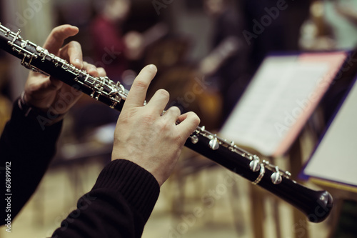 Human hands playing the oboe photo