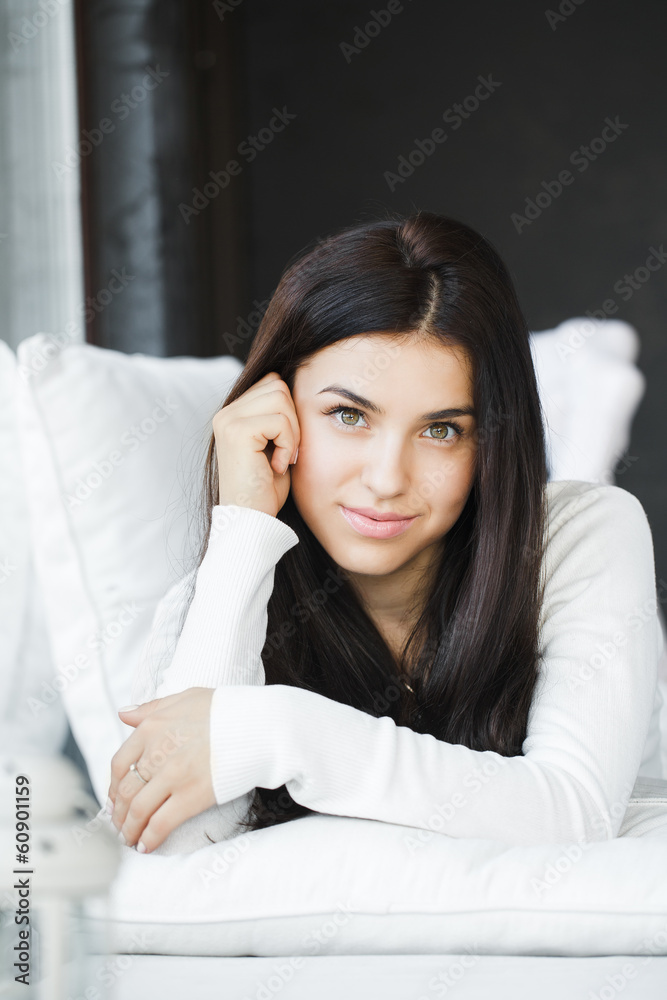 portrait of young beautiful woman on a sofa near the window portrait of young beautiful woman on a sofa near the window