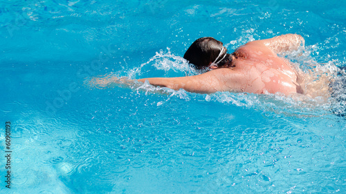 Man swimming in a pool doing the crawl