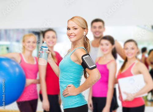 sporty woman running with smartphone and earphones