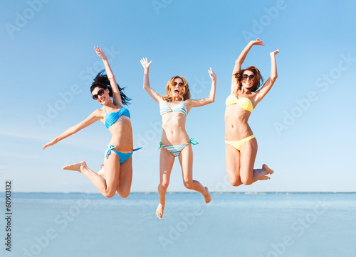 girls jumping on the beach