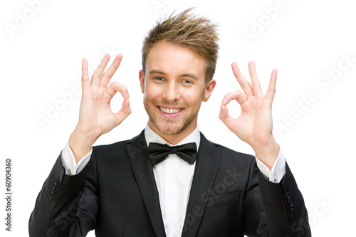 Half-length portrait of ok gesturing businessman