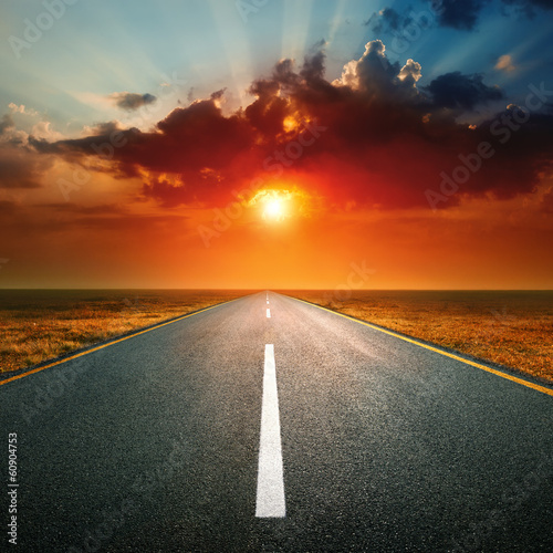 Driving on an empty road against the setting sun © rasica