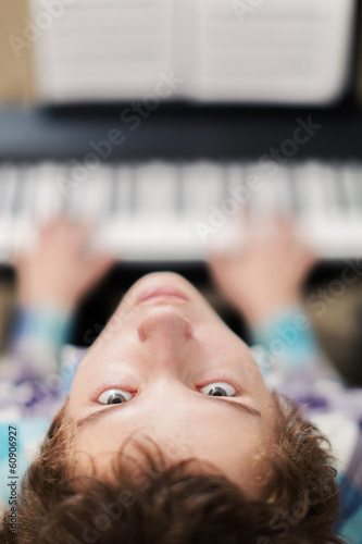 boy plays piano