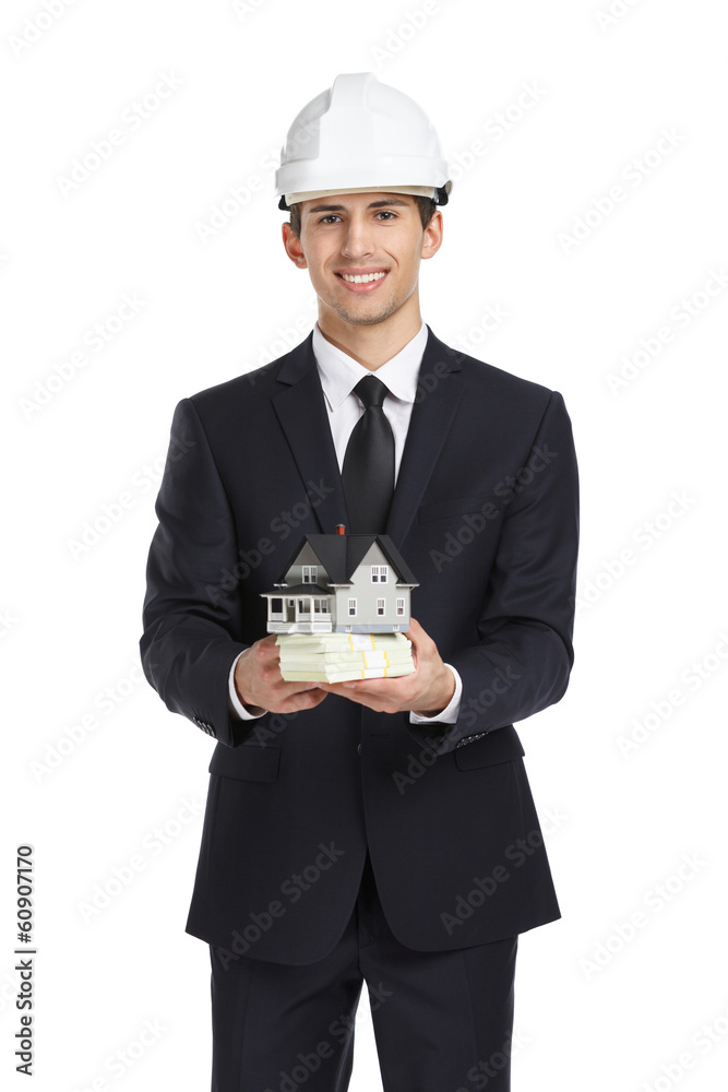 Real estate agent wearing white helmet hands model house Real estate agent wearing white helmet hands model house