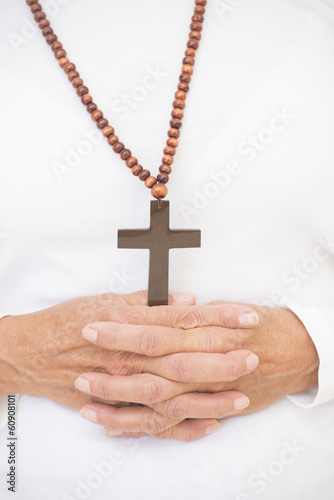 Praying hands and christian crucifix .