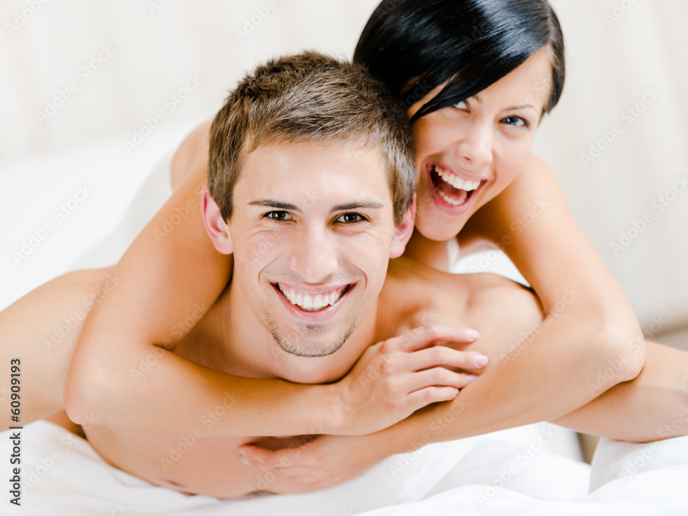 Close up of laughing couple who plays in bed Close up of laughing couple who plays in bed